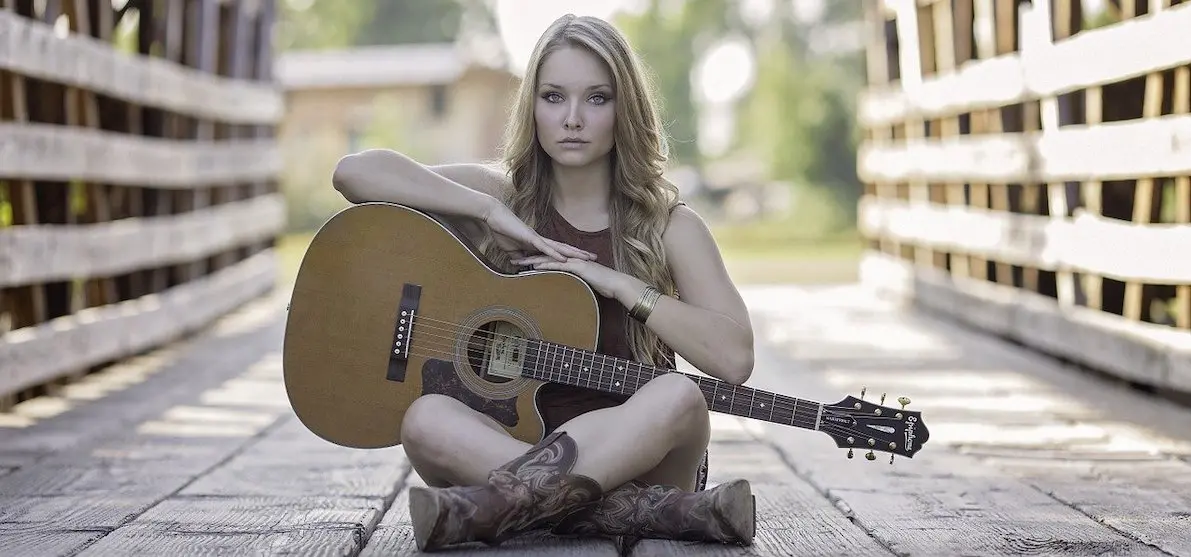Adding the right music to your marketing video: girl with guitar
