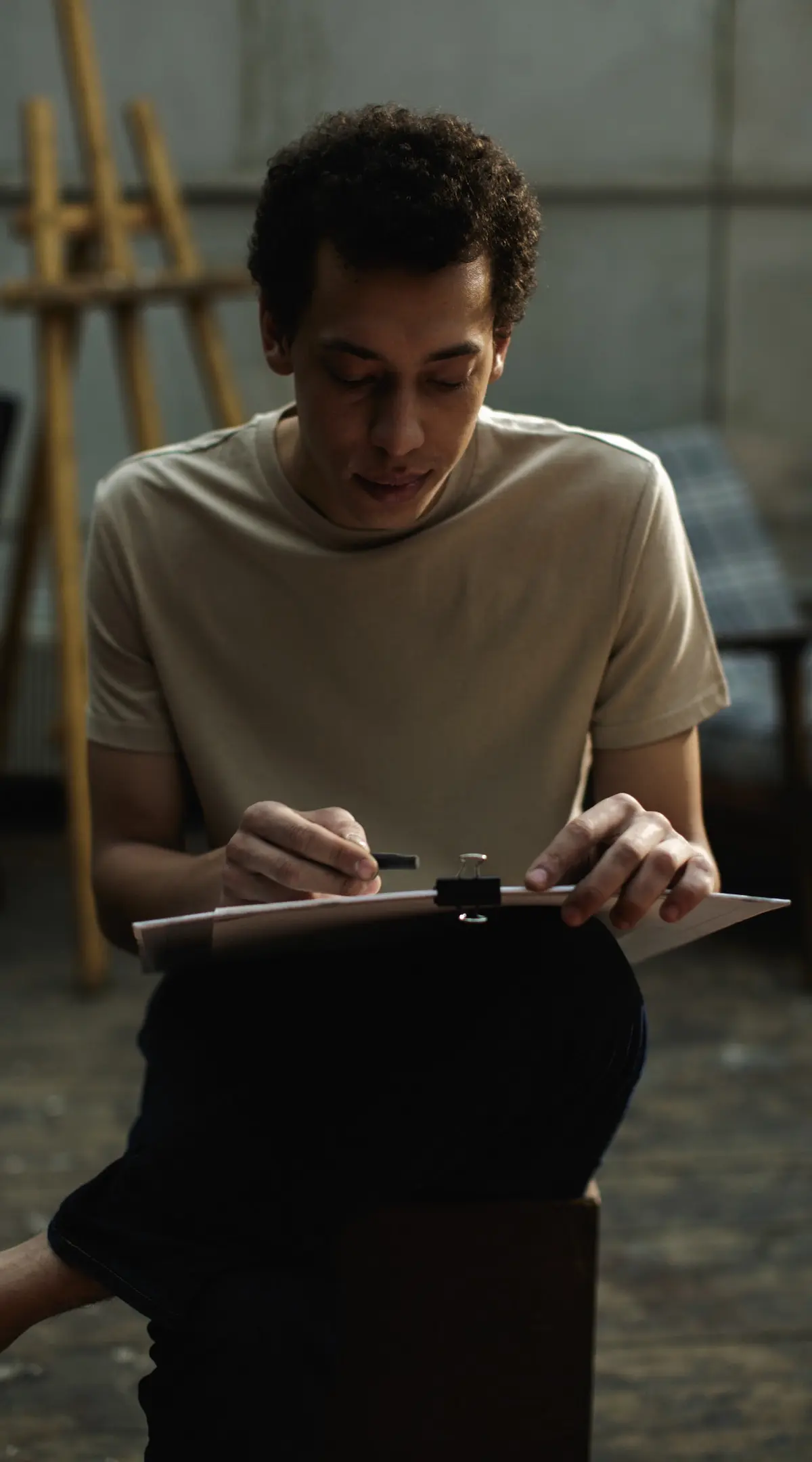 how to prepare a voice over script: man writing notes on a script