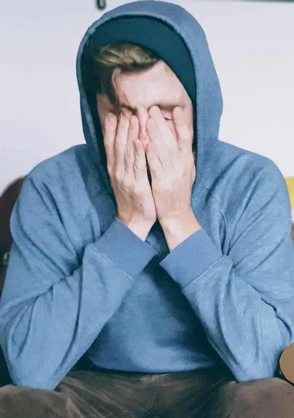 How to deal with burnout: man sitting with hands over his face
