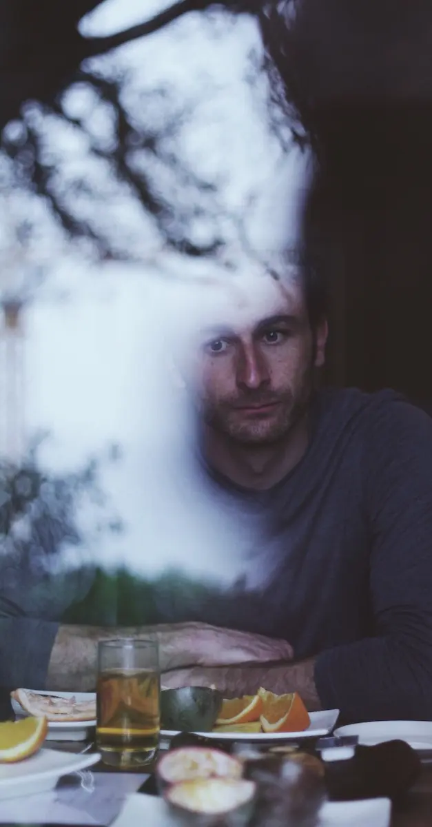 How to deal with burnout: man sitting at breakfast table thinking