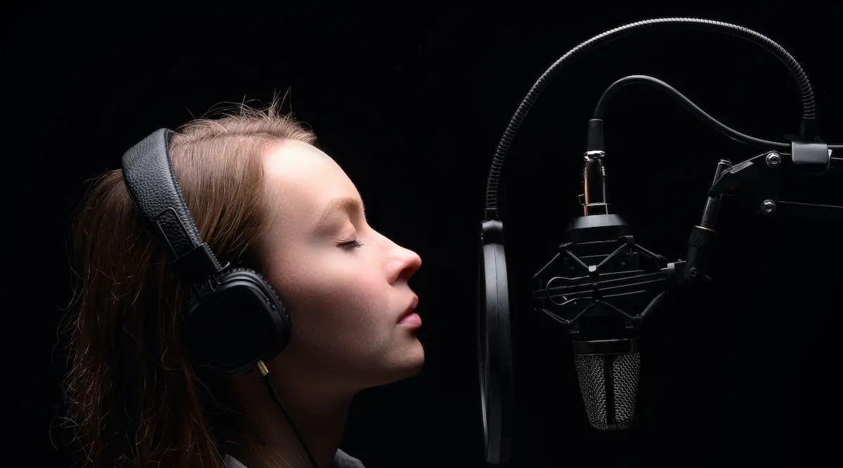 Text-to-speech: voice actress in front of a microphone
