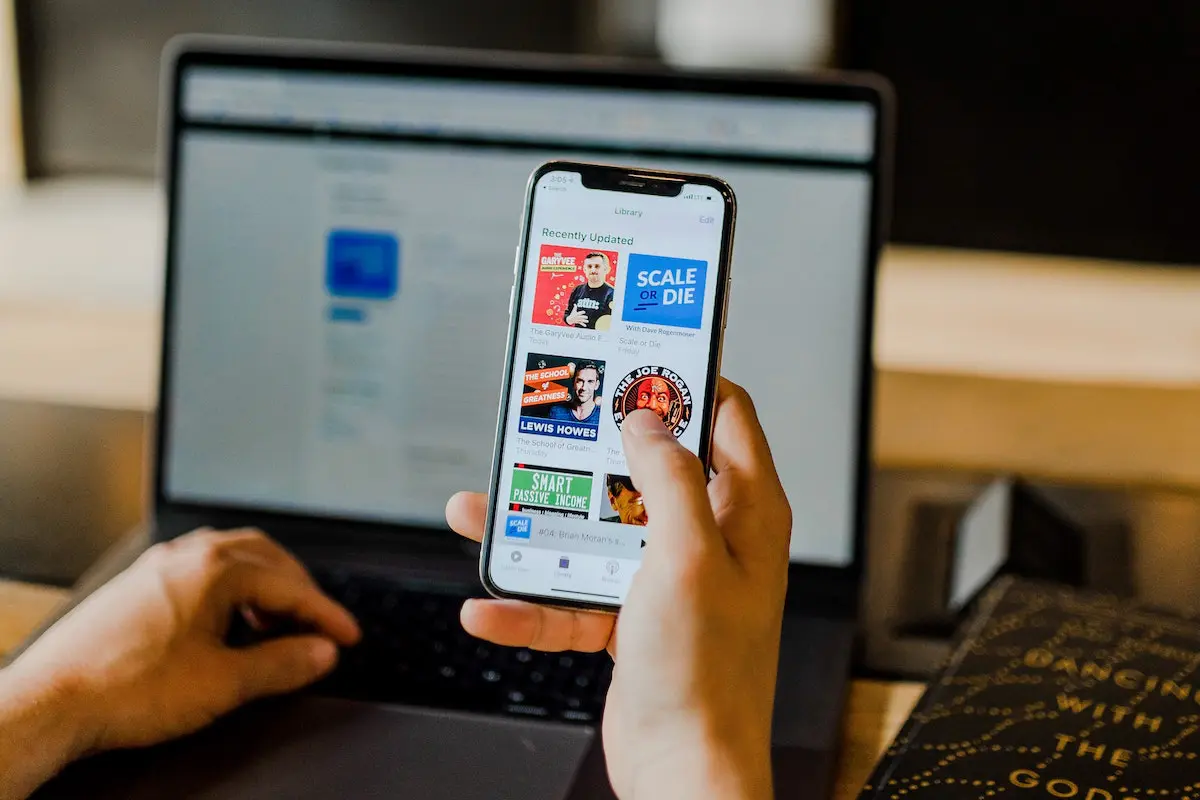 SEO and how to make it work for your business: Image of man at a laptop with a cell phone