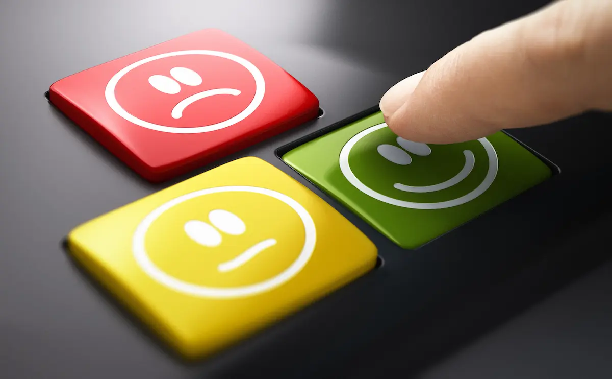 Customer experience: image of emoji buttons with a finger hovering over the green smiley button