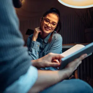 Humor in ads: a man reading a funny script to a woman colleague
