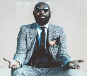 Marketing trends: image of a man siting with his hands outstretched holding a red pill and a blue pill in each hand.