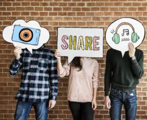 social commerce: image of people holding up social media distribution bubbles