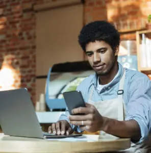 Instagram & Facebook: image of a businessman checking sales on his cellphone