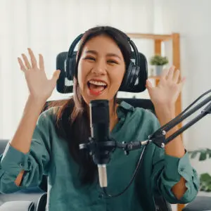 Creator Marketing: image of a young Asian woman chatting excitedly over a mic
