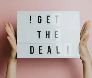 Video marketing: image of two hands holding a sign that reads: get the deal