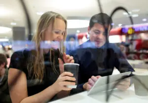 AR filters: image of a man showing images to a colleague on an iPad