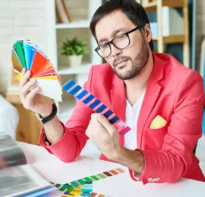 Visual techniques: a advertising creative holding a variety of colored cards in his hand