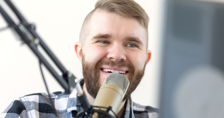 Radio, dj and broadcast concept - Portrait of handsome young man with blond hair hosting show live in studio