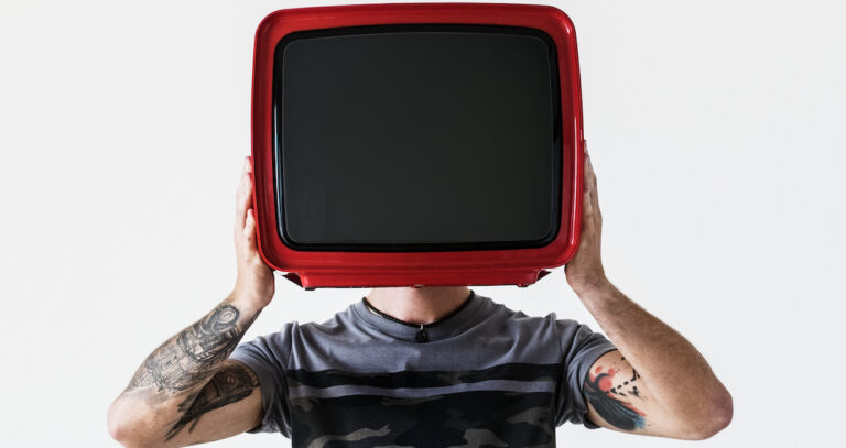 Person with tattoo holding television