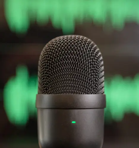 Scratch tracks: image of a microphone in fromnto of a computer screen displaying audio tracks