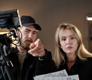 YouTube video ideas: image of a director and videographer discussing a shot.