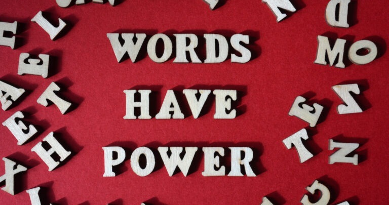 Conversational writing: image of letters of the alphabet on a board that spell: words have power.